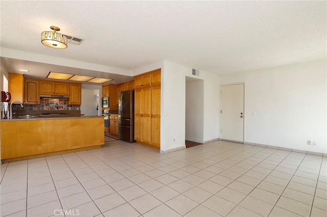 3016 Daphney Ct, Simi Valley, CA 93063 - kitchen with stainless steel appliances, a peninsula, under cabinet range hood, open floor plan, and a textured ceiling