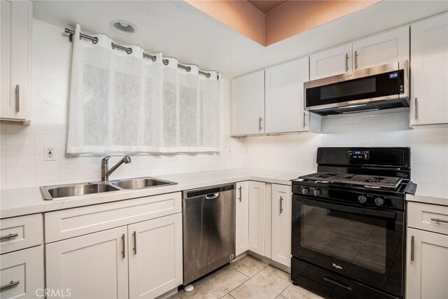 4201 W 5th St Unit 218, Santa Ana, CA 92703 - kitchen with appliances with stainless steel finishes, a sink, light countertops, light tile patterned floors, and white cabinets