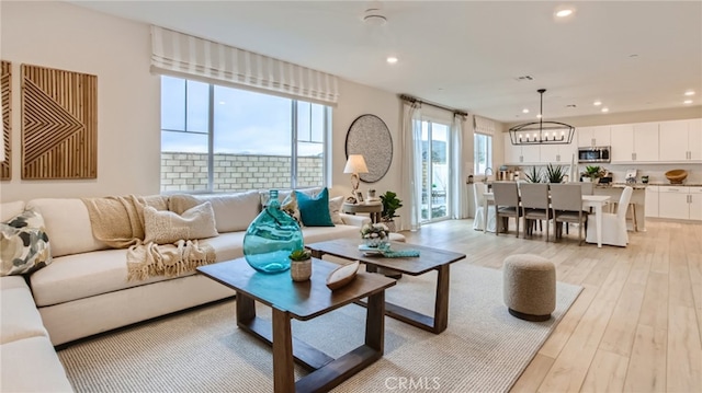 30020 Pomo Canyon Ct, Menifee, CA 92585 - living room featuring a chandelier, recessed lighting, and light wood-style flooring