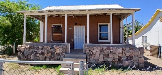 1215 Front St, Needles, CA 92363 - view of front facade featuring stucco siding and a porch