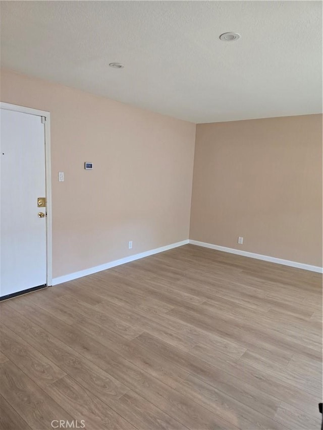 400 N Acacia Ave Unit D16, Fullerton, CA 92831 - unfurnished room with light wood-type flooring, baseboards, recessed lighting, and a textured ceiling