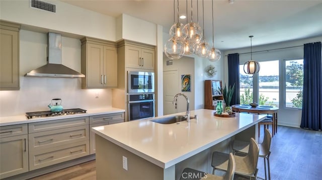 1207 Doheny Way, Dana Point, CA 92629 - kitchen featuring appliances with stainless steel finishes, wall chimney exhaust hood, light countertops, wood finished floors, and gray cabinets