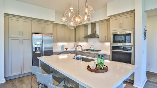 1207 Doheny Way, Dana Point, CA 92629 - kitchen featuring stainless steel appliances, wall chimney exhaust hood, wood finished floors, and light countertops
