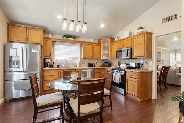 2355 S Pinehurst Pl, Ontario, CA 91761 - kitchen featuring stainless steel appliances, decorative backsplash, dark wood finished floors, brown cabinetry, and recessed lighting