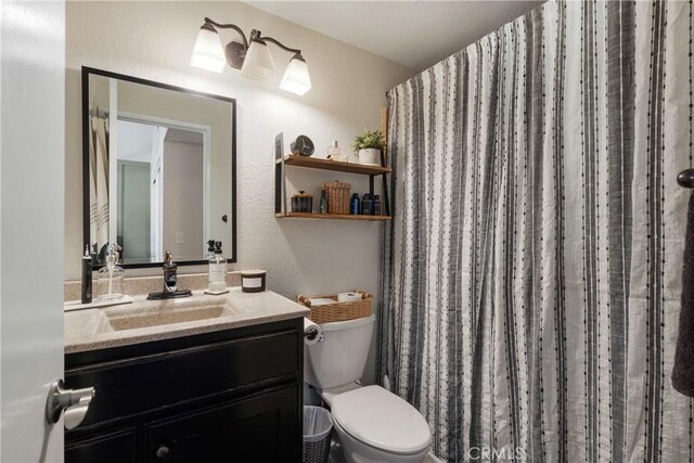 2355 S Pinehurst Pl, Ontario, CA 91761 - bathroom featuring vanity, toilet, a textured wall, and a shower with curtain