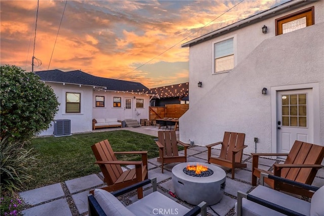 1856 W 43rd St, Los Angeles, CA 90062 - patio terrace at dusk featuring a patio, cooling unit, a lawn, and an outdoor living space with a fire pit