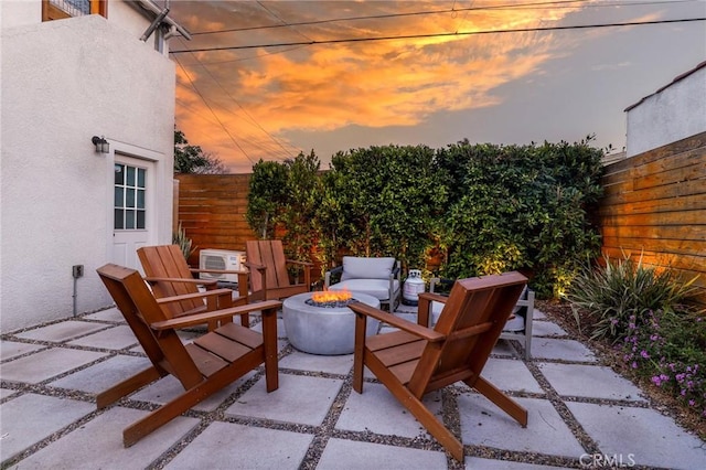 1856 W 43rd St, Los Angeles, CA 90062 - patio terrace at dusk with an outdoor fire pit and a patio area