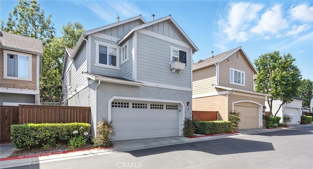 3 Bluff Cove Dr, Aliso Viejo, CA 92656 - view of front of home featuring board and batten siding, an attached garage, stucco siding, and cooling unit