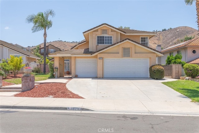 16783 Lake Knl, Riverside, CA 92503 - view of front facade featuring stucco siding, concrete driveway, a tile roof, and an attached garage