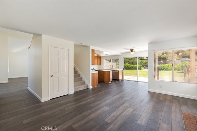 16783 Lake Knl, Riverside, CA 92503 - unfurnished living room with baseboards, dark wood-type flooring, a sink, and stairs