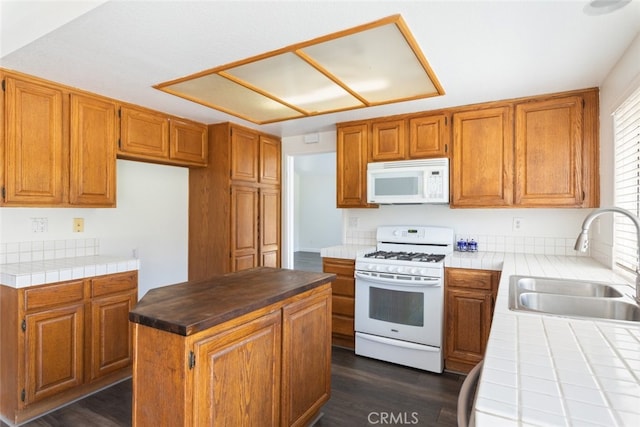 16783 Lake Knl, Riverside, CA 92503 - kitchen featuring white appliances, a sink, tile countertops, a center island, and brown cabinets