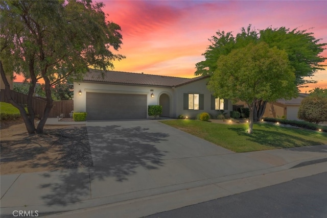 36867 Gallery Ln, Beaumont, CA 92223 - view of front facade featuring driveway, a tiled roof, an attached garage, and stucco siding
