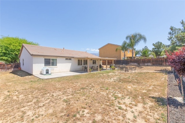 36867 Gallery Ln, Beaumont, CA 92223 - rear view of house featuring a fenced backyard, a patio, stucco siding, and a tile roof