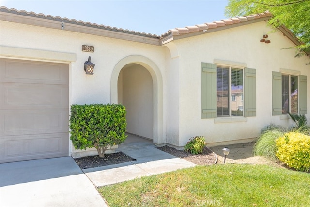 36867 Gallery Ln, Beaumont, CA 92223 - doorway to property with stucco siding, an attached garage, and a tile roof