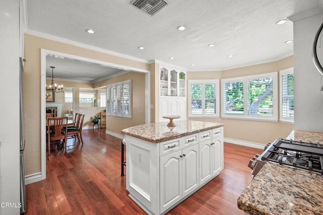 829 E Ada Ave, Glendora, CA 91741 - kitchen with baseboards, stainless steel gas range, dark wood-style flooring, a kitchen island, and white cabinets
