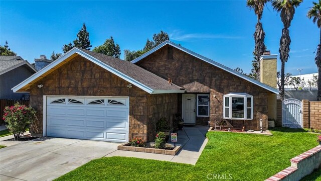 3012 Homer Cir, Jurupa Valley, CA 91752 - view of front of house with an attached garage, driveway, a chimney, a gate, and stone siding