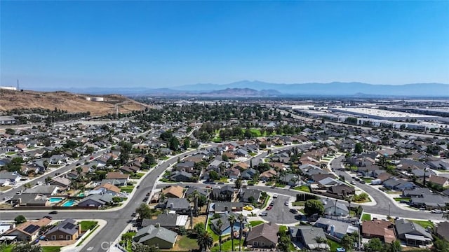 3012 Homer Cir, Jurupa Valley, CA 91752 - aerial view of property and surrounding area featuring a mountain backdrop and nearby suburban area