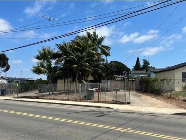 2840 Ridgeway Dr, National City, CA 91950 - view of asphalt street with sidewalks, curbs, and a gate