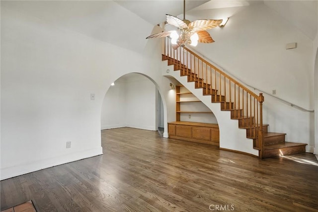 915 Poplar St, Chico, CA 95928 - unfurnished living room featuring high vaulted ceiling, ceiling fan, wood finished floors, arched walkways, and stairs