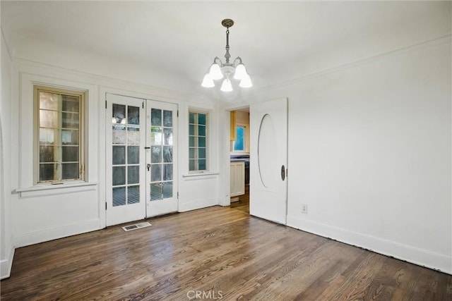 915 Poplar St, Chico, CA 95928 - unfurnished dining area with a chandelier, wood finished floors, baseboards, and french doors