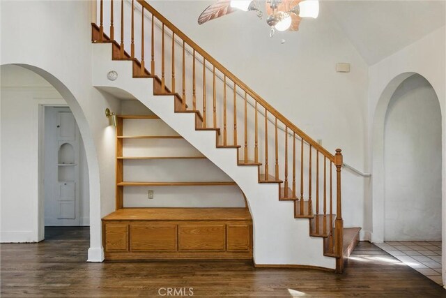 915 Poplar St, Chico, CA 95928 - stairs with a ceiling fan, arched walkways, wood finished floors, and high vaulted ceiling