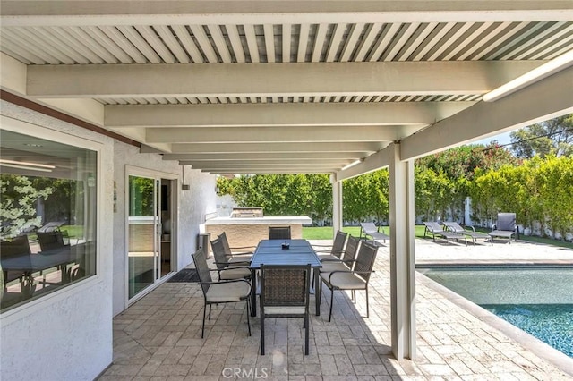 2230 N Volturno Rd, Palm Springs, CA 92262 - view of patio featuring exterior kitchen, an outdoor pool, and outdoor dining space