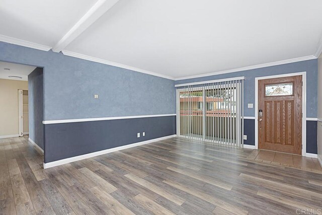 575 7th St # 203, Imperial Beach, CA 91932 - unfurnished living room with wood finished floors, baseboards, ornamental molding, and beamed ceiling