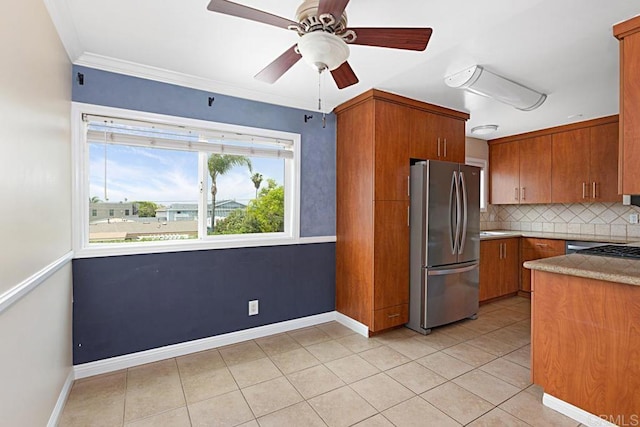 575 7th St # 203, Imperial Beach, CA 91932 - kitchen featuring freestanding refrigerator, brown cabinetry, tasteful backsplash, ceiling fan, and light tile patterned flooring