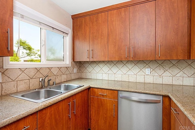575 7th St # 203, Imperial Beach, CA 91932 - kitchen featuring stainless steel dishwasher, tasteful backsplash, brown cabinets, a sink, and light stone countertops