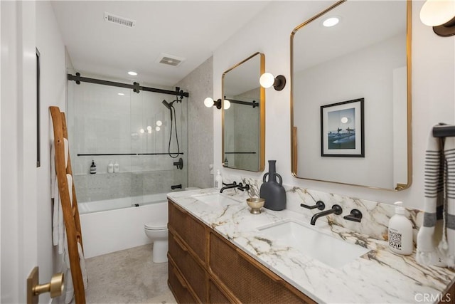 2317 Via Zafiro, San Clemente, CA 92673 - bathroom featuring double vanity, bath / shower combo with glass door, toilet, and recessed lighting