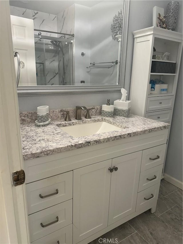 8730 Twin Trails Dr, San Diego, CA 92129 - bathroom with a marble finish shower, vanity, and marble look tiles