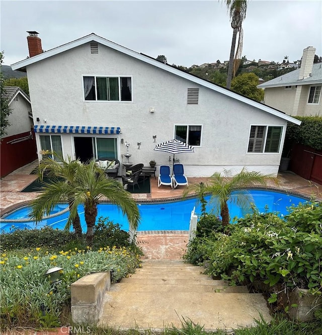 8730 Twin Trails Dr, San Diego, CA 92129 - rear view of property featuring a patio area, stucco siding, a chimney, and an outdoor pool