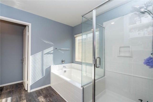 2038 Mesquite Ln, Colton, CA 92324 - full bathroom featuring a stall shower, a bath, wood finished floors, and baseboards