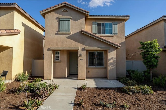2038 Mesquite Ln, Colton, CA 92324 - view of front of property featuring stucco siding, a tiled roof, and a patio