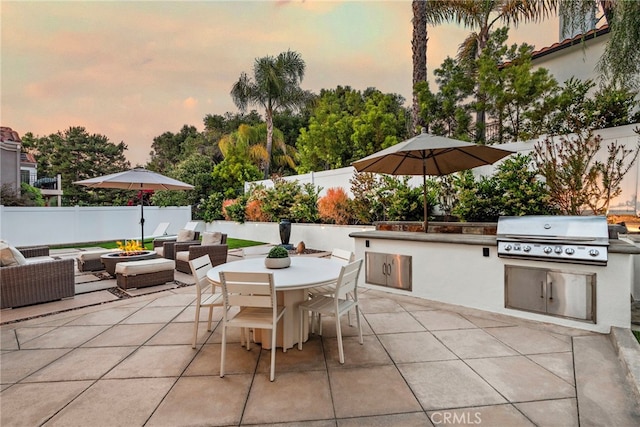 38 Via Sonrisa, San Clemente, CA 92673 - patio terrace at dusk with a patio, outdoor dining area, a fenced backyard, and an outdoor living space with a fire pit