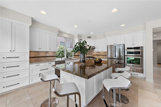 38 Via Sonrisa, San Clemente, CA 92673 - kitchen with a warming drawer, appliances with stainless steel finishes, a kitchen breakfast bar, backsplash, and recessed lighting