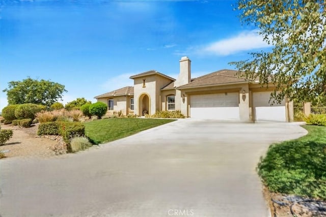 889 Highridge St, Riverside, CA 92506 - mediterranean / spanish home with an attached garage, driveway, stucco siding, and a chimney