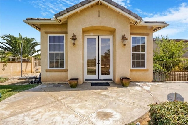 889 Highridge St, Riverside, CA 92506 - view of exterior entry with french doors, stucco siding, and a patio area