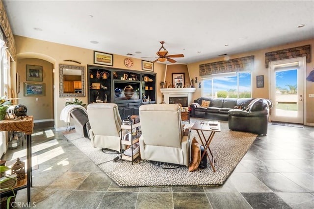 889 Highridge St, Riverside, CA 92506 - living area featuring ceiling fan, a fireplace, stone tile floors, baseboards, and recessed lighting