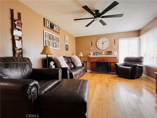 10141 Orange St, Rancho Cucamonga, CA 91737 - living room featuring a ceiling fan, light wood finished floors, a brick fireplace, and baseboards
