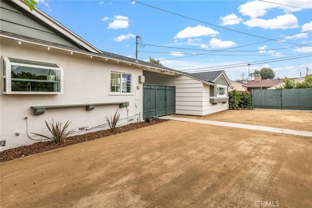 16801 Nordhoff St, Northridge, CA 91343 - view of side of home featuring stucco siding