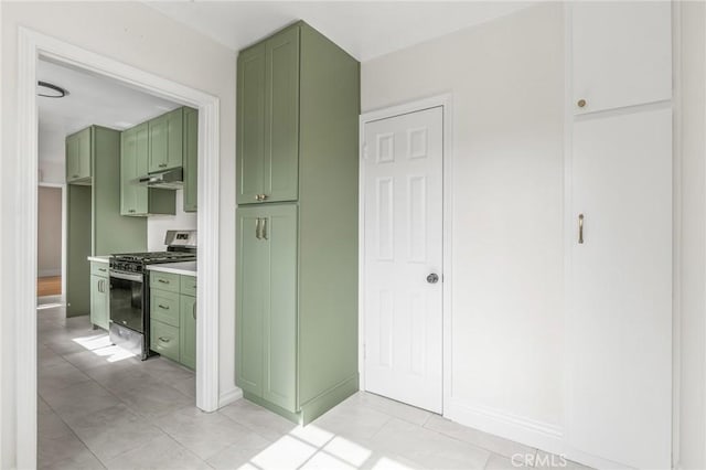 16801 Nordhoff St, Northridge, CA 91343 - kitchen with green cabinets, stainless steel range with gas stovetop, under cabinet range hood, light tile patterned floors, and light countertops