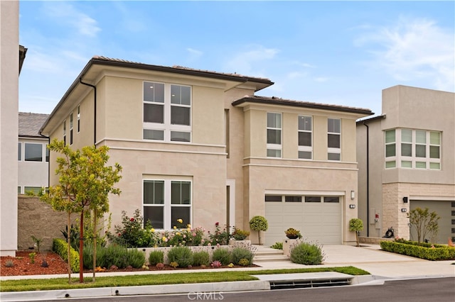 271 Huckleberry, Lake Forest, CA 92630 - view of front facade with driveway, an attached garage, and stucco siding