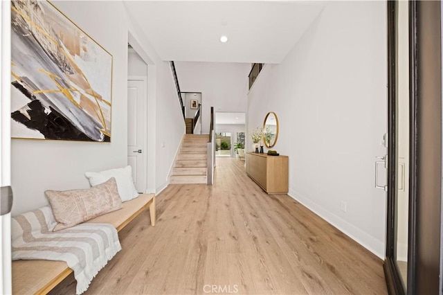 271 Huckleberry, Lake Forest, CA 92630 - hallway with light wood finished floors, stairs, baseboards, and recessed lighting