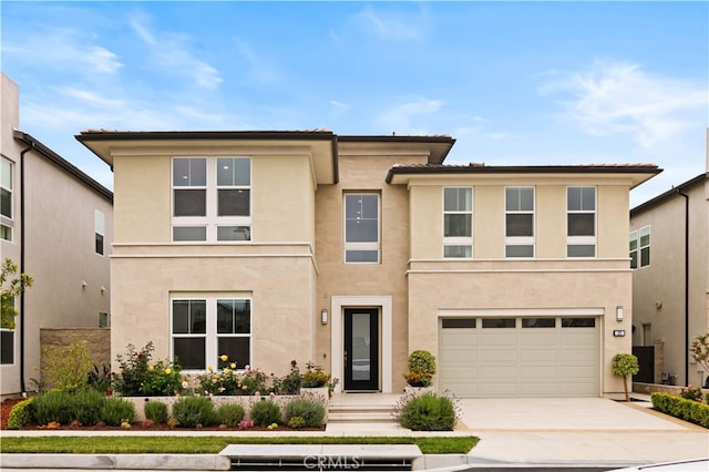 271 Huckleberry, Lake Forest, CA 92630 - view of front of property featuring driveway, stucco siding, and an attached garage