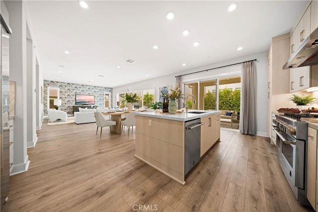 271 Huckleberry, Lake Forest, CA 92630 - kitchen with appliances with stainless steel finishes, light brown cabinets, a sink, modern cabinets, and wall chimney exhaust hood