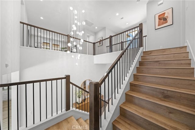 271 Huckleberry, Lake Forest, CA 92630 - staircase featuring a chandelier, a towering ceiling, and recessed lighting