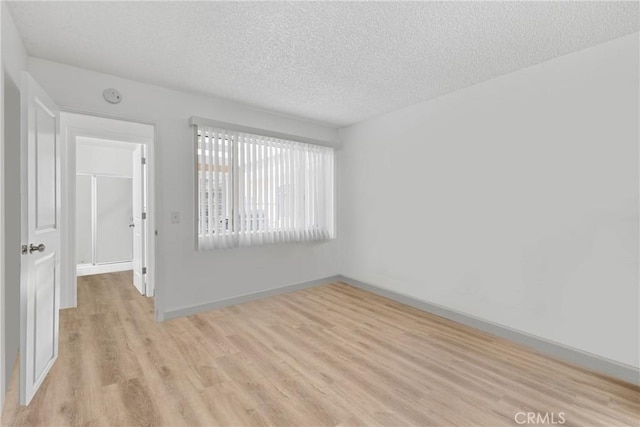 356 Myrl Pl, Hemet, CA 92545 - empty room with light wood finished floors, a textured ceiling, and a smoke detector