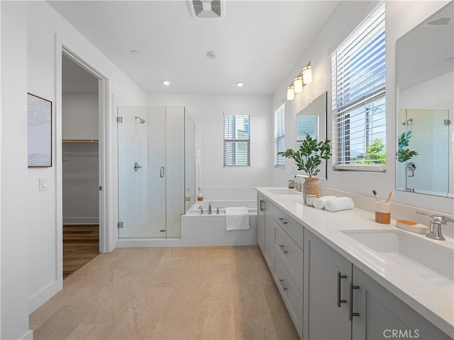 191 Lynx, Irvine, CA 92618 - bathroom featuring a shower stall, a garden tub, double vanity, recessed lighting, and a walk in closet