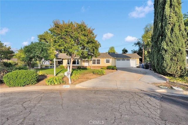 11777 Preston Ln, Yucaipa, CA 92399 - ranch-style home featuring concrete driveway, a front lawn, and a garage
